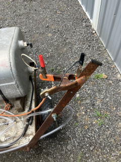 Spring clamp with switch and alligator clips for battery connection.