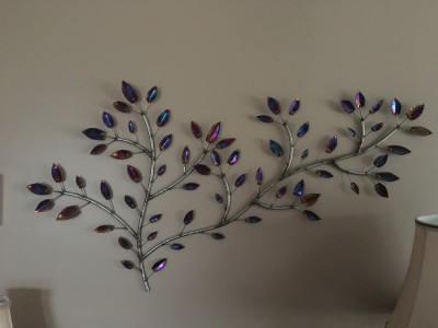 This piece is what you see when you come in the front door. All different colors that looks like a vine growing on the wall.