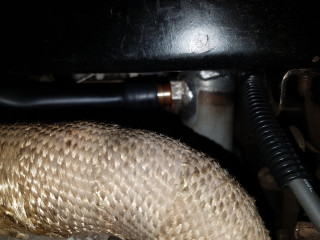 2" of fuel filler hose from Carquest (sold by the inch) joins it to the valve cover and is tall enough that the air filter housing holds it in place