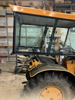 Cab extends behind tractor