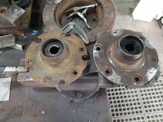 the rear hubs were drilled and a bolting plate attached to the back for the modern wheels . before and after welding hole closed