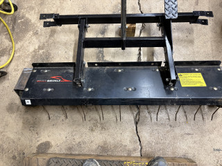 Brinly dethatcher with new fabricated brackets to fit front of Walker Zero turn.