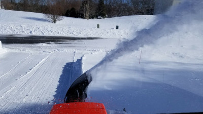 I'm actually throwing the snow slightly backwards in these pictures to try and keep the snow out of the road.