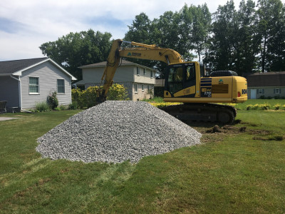 Stone dumped near excavator