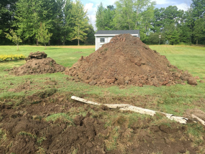 dirt pile to be moved behind shed