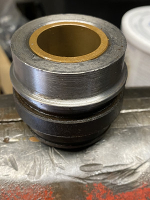 The second gland shows the bronze bushing flush, so the other one must be pressed in.