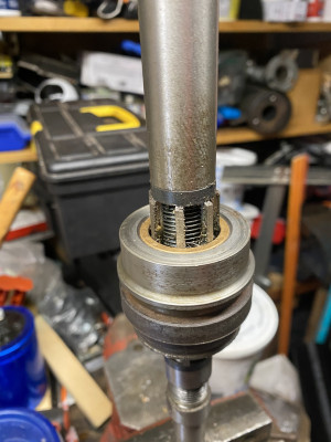 Adjusting it the tiniest bit at a time, cutting, then testing it on the rod ended up with a nice fit. Don't know what I'd have done without the reamer.