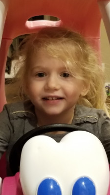 Lily playing in her cozy coupe.