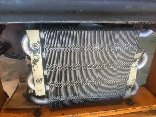 Oil cooler cleaned and remounted with rubber on both sides of cooler tubes.